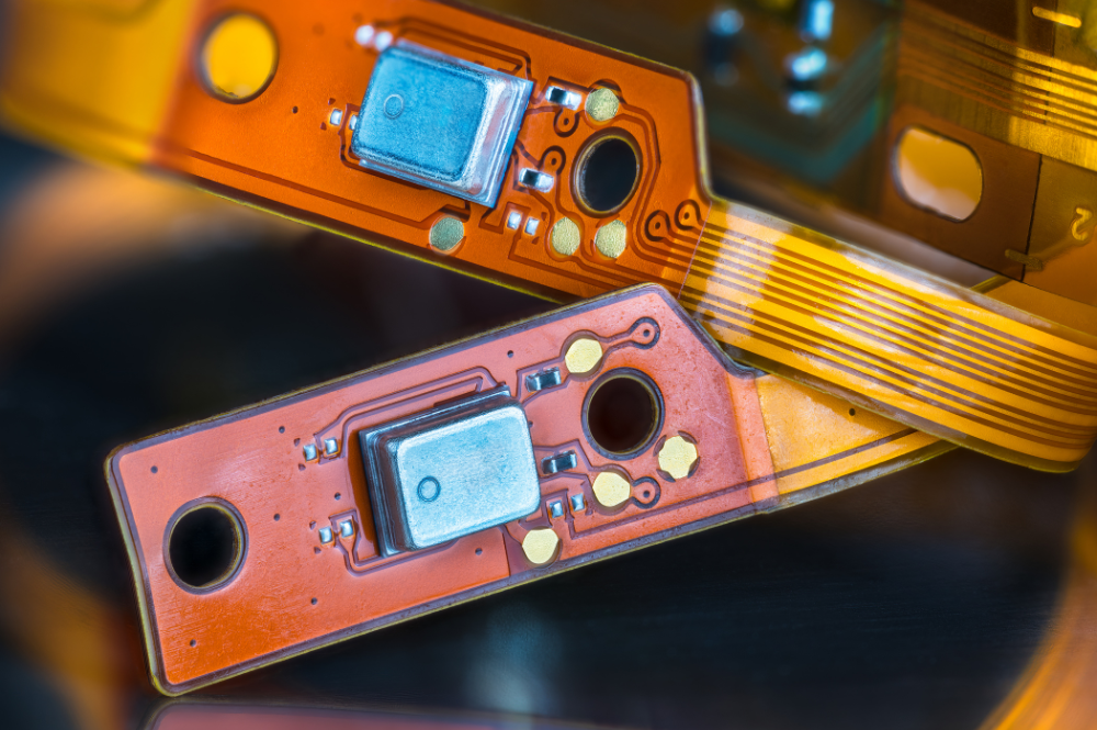 Close-up of two rigid flex PCBs showcasing intricate electronic components and connections.